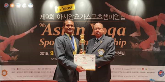 Mr. Chandrakant Pangare receiving a Gold Medal at the Asian Yoga Sports Championship